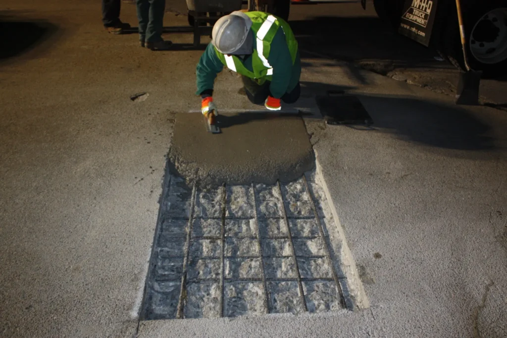 Professional concrete resurfacing at night, showcasing Concrete Rotorua's reliable concrete repairs services.